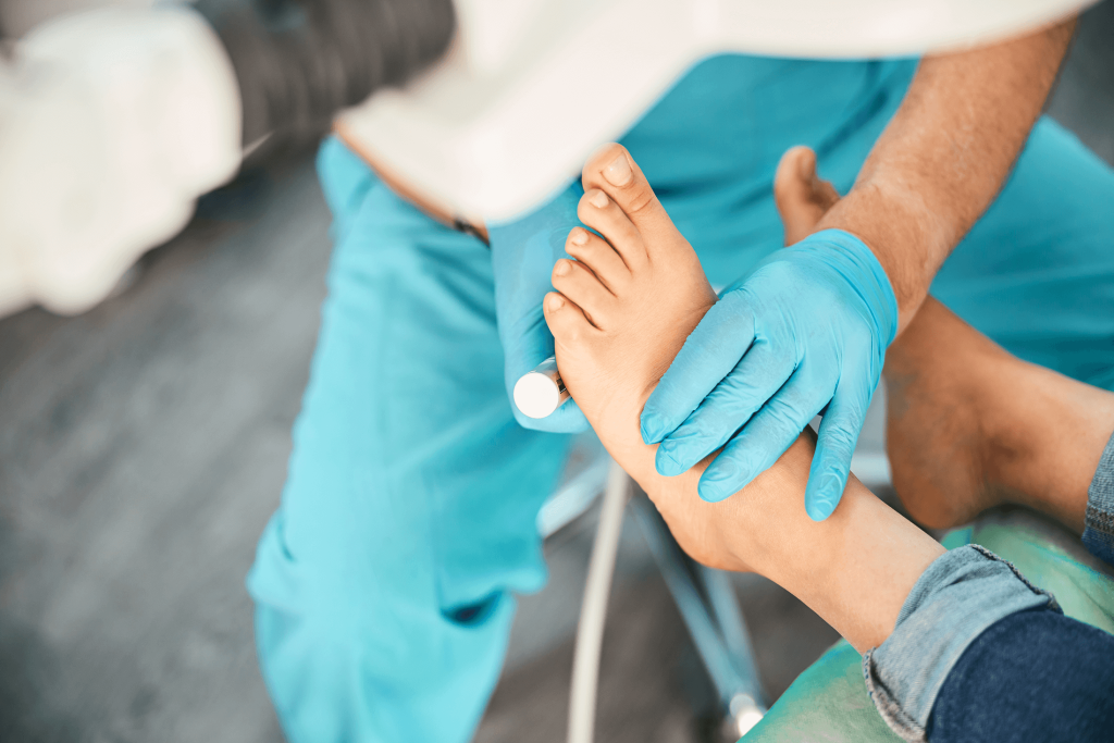 Professional podiatrist using nail instrument to treat feet in a foot clinic