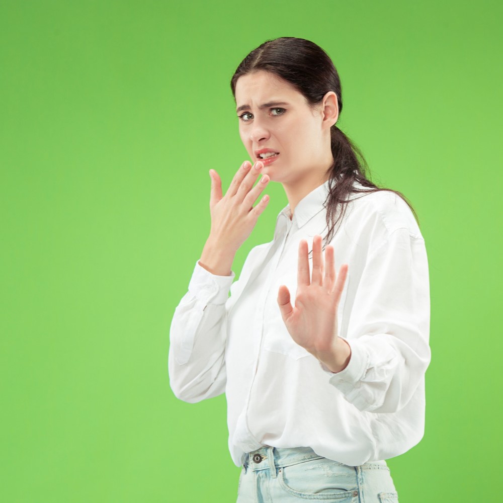 Reject, rejection, doubt concept. doubtful woman with thoughtful expression making choice. young emotional woman. human emotions, facial expression concept. studio. isolated on trendy green. Dry mouth concept.